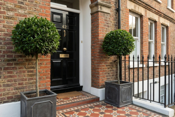 Topiary Planters And The Trick Of Symmetry By The Door